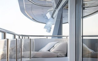 bed-with-white-sheets-balcony-with-glass-door