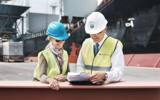 two-dock-workers-holding-paperwork-while-standing-2023-11-27-05-01-41-utc-min